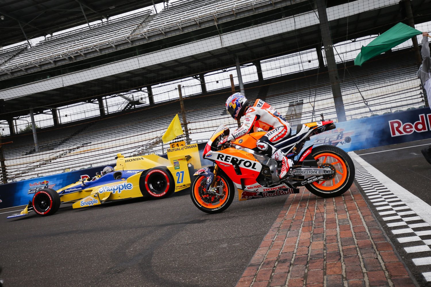 Watch a MotoGP Bike Race an IndyCar at the Indianapolis Motor Speedway
