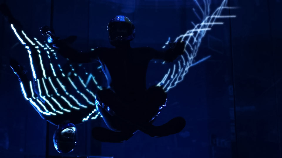 Two Red Bull Athletes Perform Skydiving Stunts With LED Light Suits Inside a Wind Tunnel